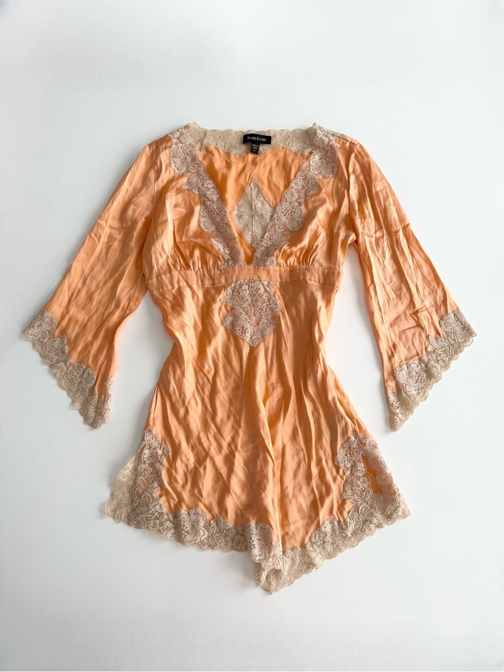 Bebe orange lace trim silk asymmetrical blouse.